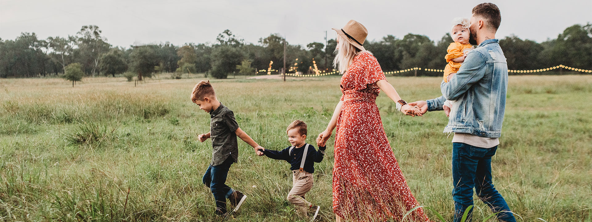 Family walking through a field.